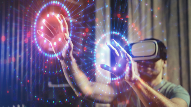 Person wearing a VR headset interacting with a glowing digital interface using his hands.