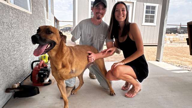 A man with an amputated arm, his wife, and a dog with an amputated leg.