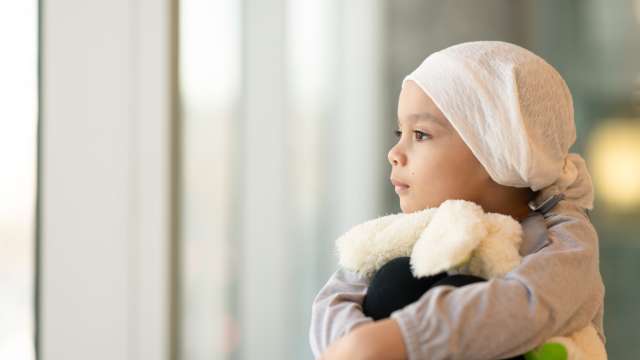 child with cancer gazing out the window