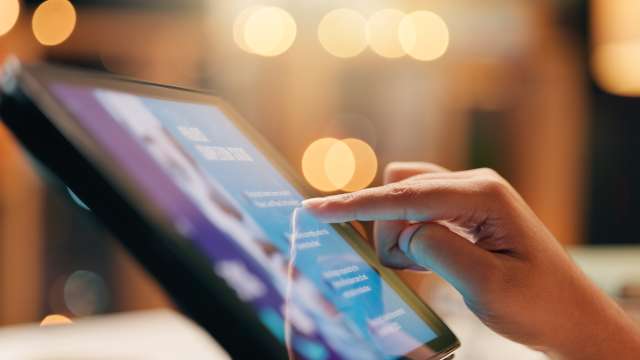 Hand at computer tablet