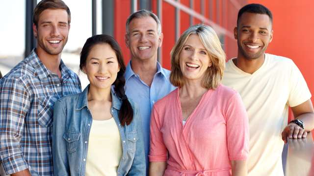 Diverse group at workplace — five coworkers standing together