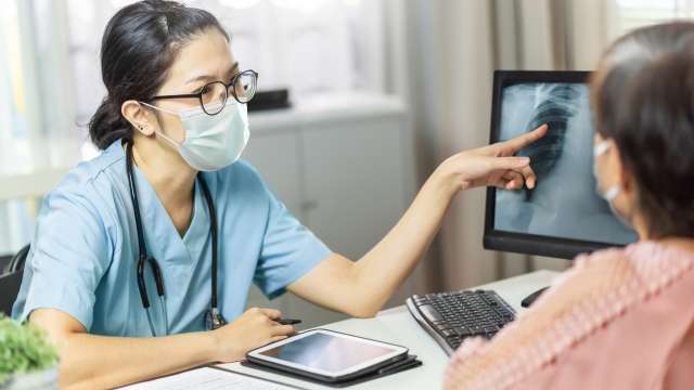 Doctor shows a scan to a lung cancer patient