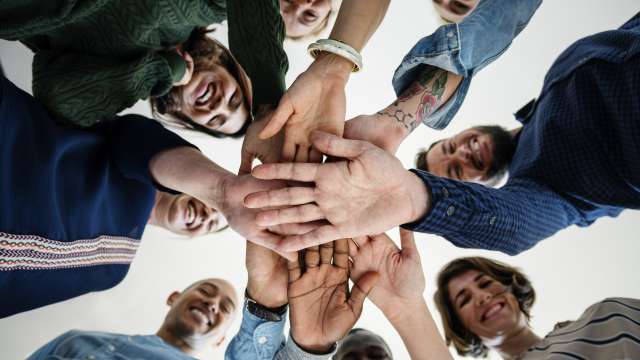Group of cancer patients holding hands in a circle