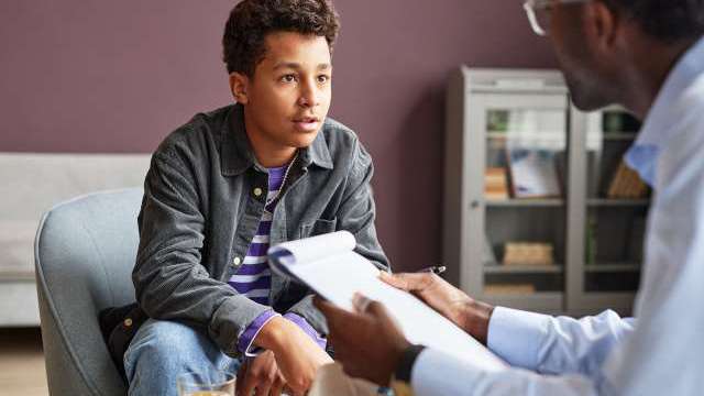 Young adult speaking to a doctor at the AYA Cancer Center Simms Mann