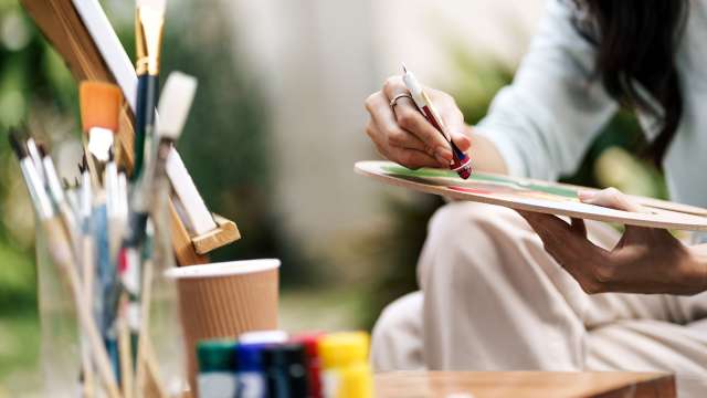 Woman sitting and painting a picture