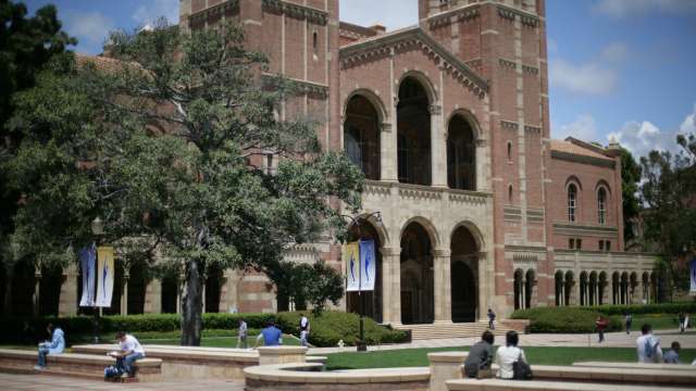 Students relax near Royce Hall on a sunny day at UCLA.