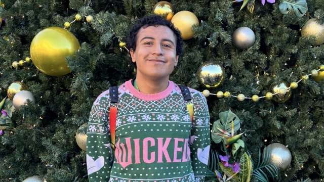 Brandon Chico in front of a Christmas tree.