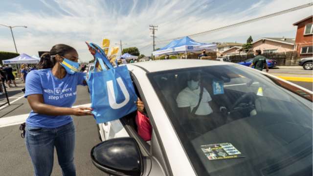UCLA Health employee helping provide gift bags for patrons.