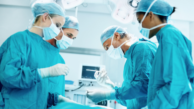 Surgeons performing a procedure in an operating room.