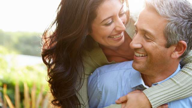 Couple hugging in a field