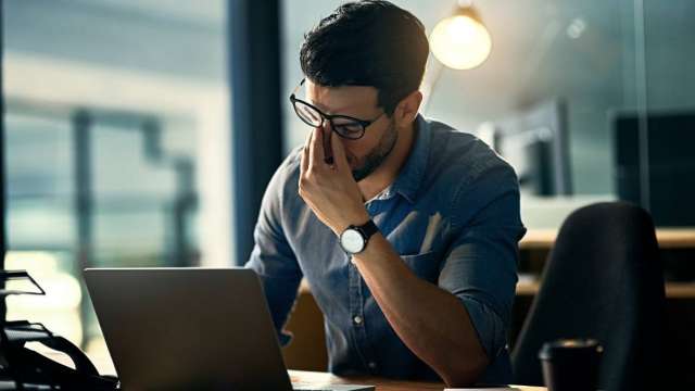 Man stressed at computer
