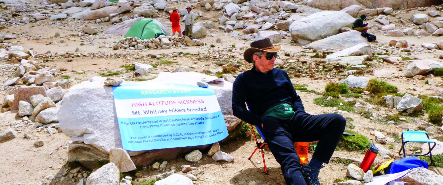 Man posing in front of mountains