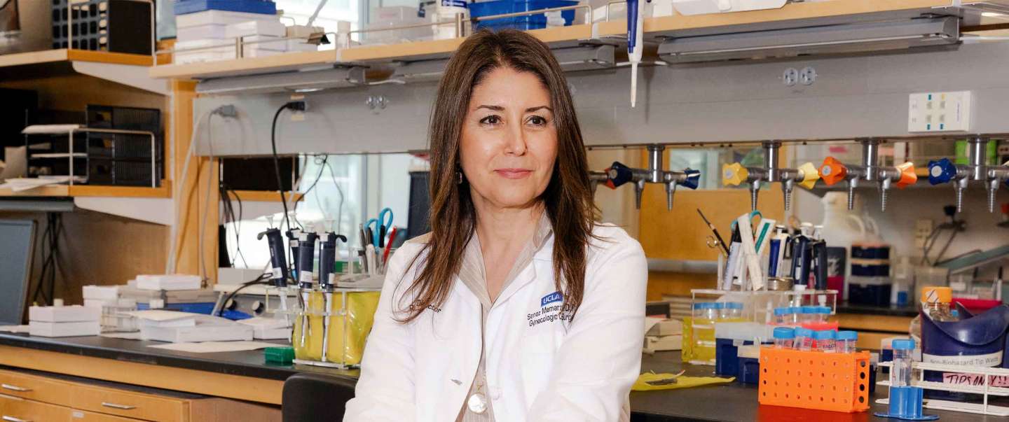 Dr. Sanaz Memarzadeh sitting in a desk chair in the Lab.
