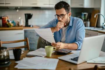 Man overwhelmed with paperwork