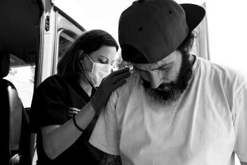 Dr. Catherine M. Weaver examines a patient. (Photo by Ara Oshagan)