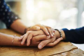 Hands held for support