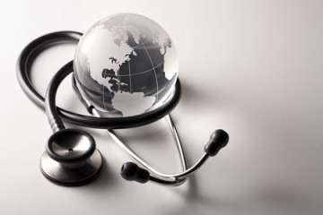 Globe with a stethoscope draped around it