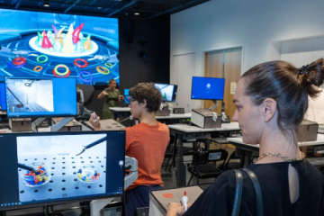 Two students participating on intensive robotic surgery simulation training at CASIT.