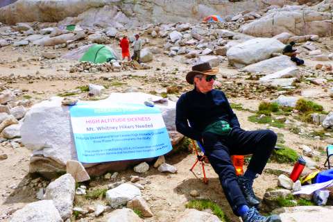 Man posing in front of mountains