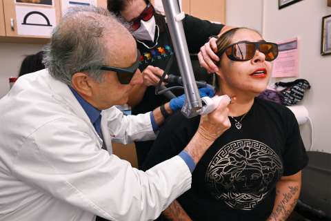 doctor removing tattoo with laser