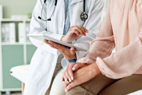 Clinic, tablet and hands of doctor with patient for consulting, medical service and help in hospital.