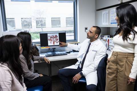 Doctor, medical staff examine scan