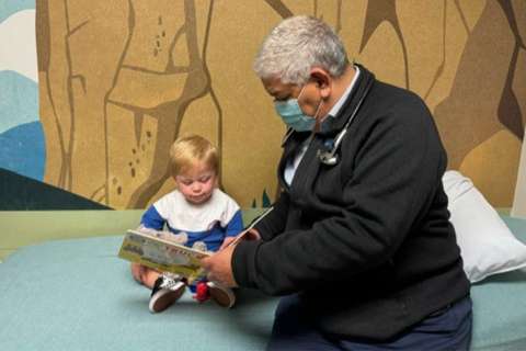 Dr. Juan Alejos reads to Levi Jonathan.