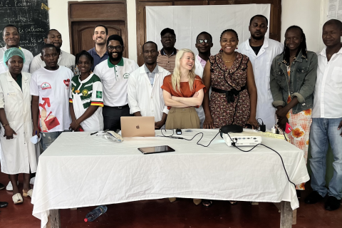 A group of doctors poses for a photo behind a table.