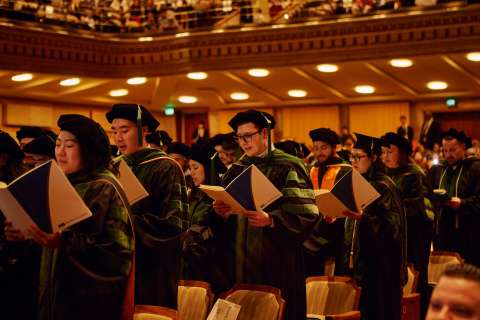 Graduating doctors read the Hippocratic oath in the Royce Hall auditorium at UCLA.