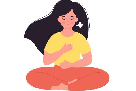 Person cross-legged meditating with hand on chest and abdomen, eyes closed.