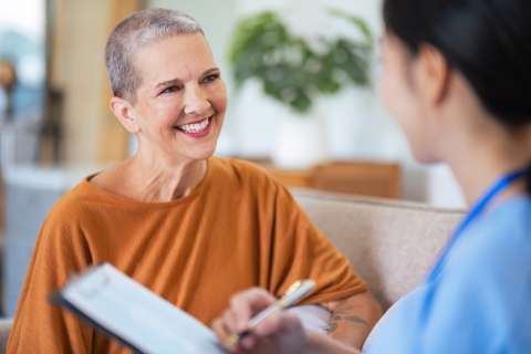 Female patient speaking with a nurse in the clinic waiting room