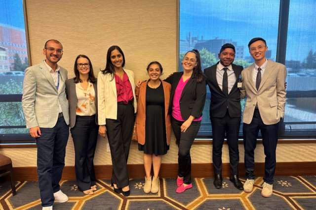 group of seven hem-on fellows posing together at a conference
