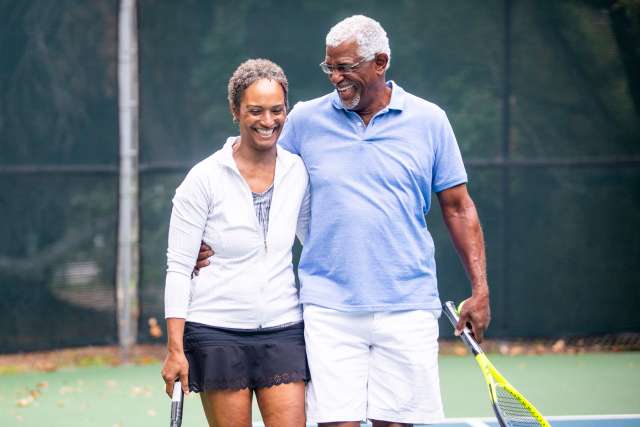Older couple playing tennis