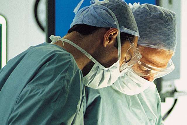 Surgeons operating on a patient, surgery