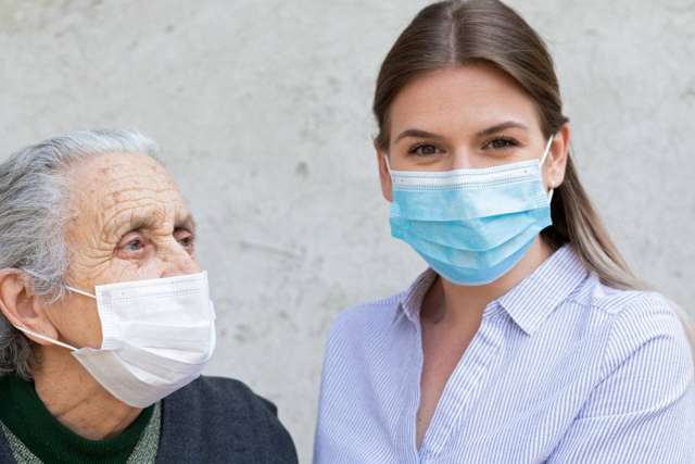 Young woman and elderly woman wearing face masks