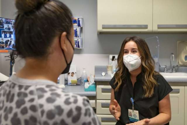 Rachel Frankenthal sitting in an office with a patient