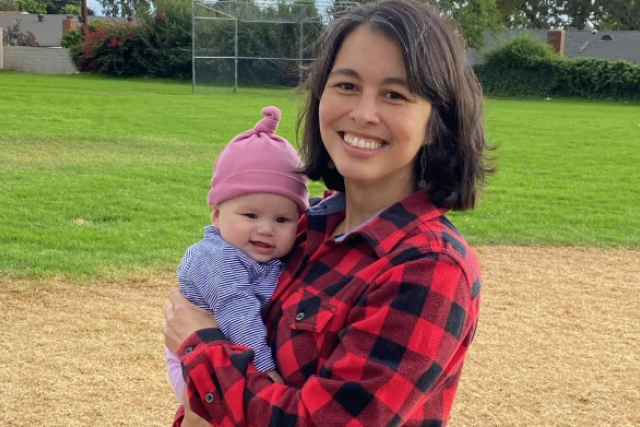 Multilingual speech therapist Camila Guerrero at a park holding a baby