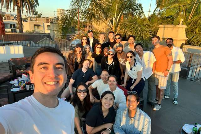 group of PMR residents posing for a picture at a rooftop bbq