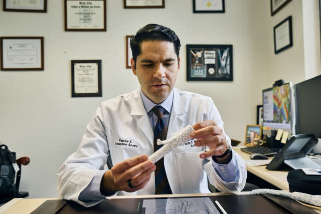 Dr. Bernardo Mendes with the branched stent graft.