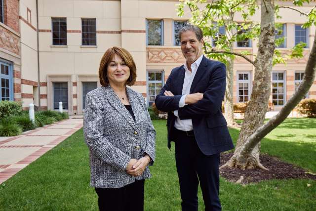 Two Santa Monica hospital board members stand together in the hospital courtyard.