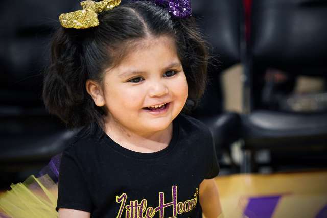 Olivia Lopez celebrates on the Los Angeles Lakers basketball court during her Laker For a Day experience.