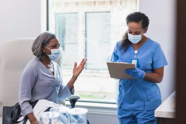 nurse listening to patient