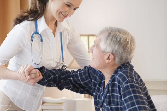 Nurse holding man's arm