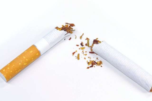Broken cigarette with spilled tobacco