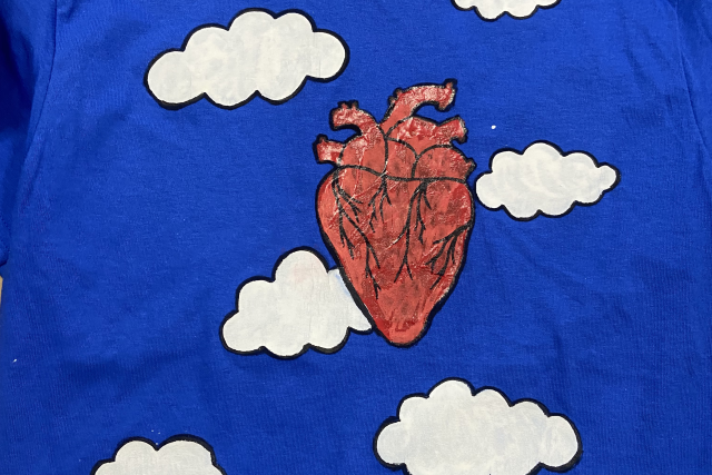 A painting of puffy white clouds around a human heart.