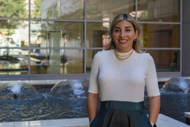 Alice Resnick posing in front of water fountains