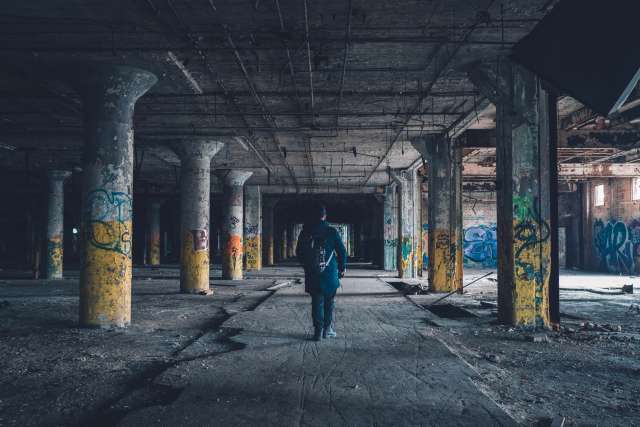 Man walking under overpass