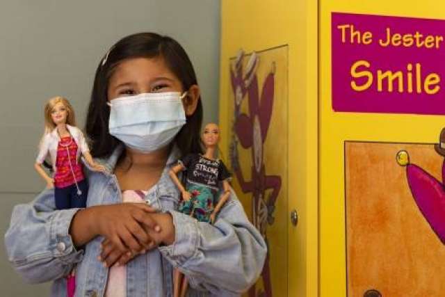 Layla Lopez, 5, cradles Mattel's Dr. Barbie and Brave Barbie