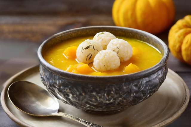 Korean Pumpkin Porridge in bowl Next to Squash