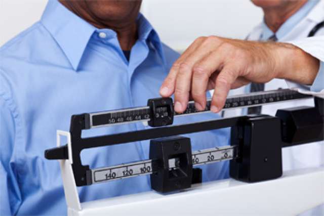 Man being weighed on a scale